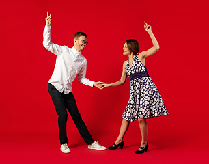 Image showing Old-school fashioned young couple dancing isolated on red background