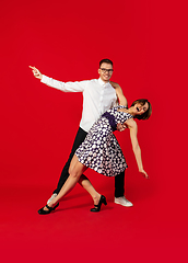 Image showing Old-school fashioned young couple dancing isolated on red background
