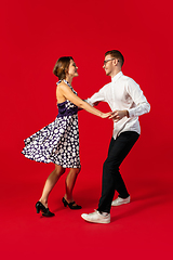 Image showing Old-school fashioned young couple dancing isolated on red background