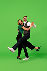 Image showing Old-school fashioned young woman dancing isolated on green background