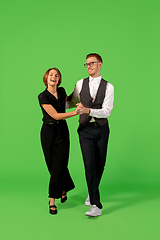 Image showing Old-school fashioned young woman dancing isolated on green background