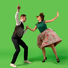 Image showing Old-school fashioned young woman dancing isolated on green background