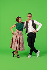 Image showing Old-school fashioned young woman dancing isolated on green background