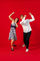 Image showing Old-school fashioned young couple dancing isolated on red background