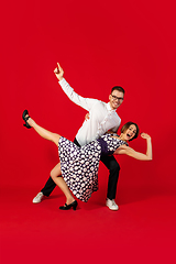 Image showing Old-school fashioned young couple dancing isolated on red background