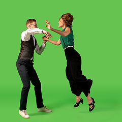 Image showing Old-school fashioned young woman dancing isolated on green background