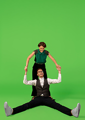 Image showing Old-school fashioned young woman dancing isolated on green background