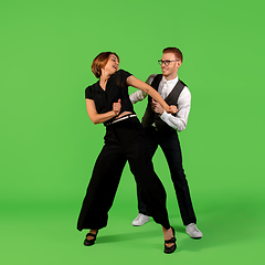 Image showing Old-school fashioned young woman dancing isolated on green background