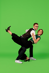 Image showing Old-school fashioned young woman dancing isolated on green background