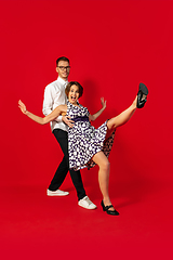 Image showing Old-school fashioned young couple dancing isolated on red background