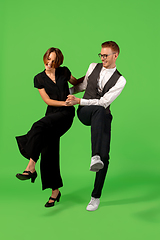 Image showing Old-school fashioned young woman dancing isolated on green background