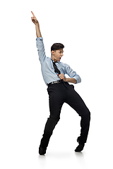 Image showing Happy young man dancing in casual clothes or suit, remaking legendary moves of celebrity from culture history