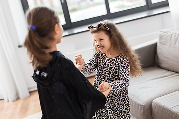 Image showing girls in halloween costumes dancing at home