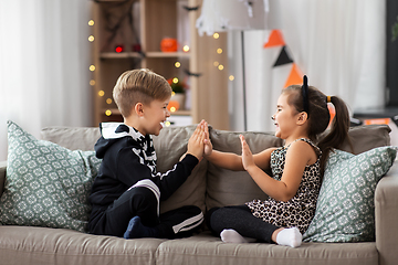 Image showing kids in halloween costumes playing game at home