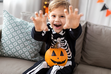 Image showing happy boy in halloween costume of skeleton at home