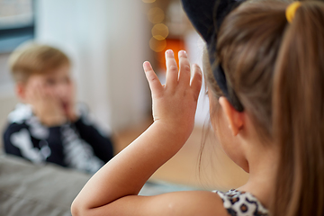 Image showing kids in halloween costumes having fun at home