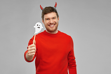 Image showing happy man in halloween costume of devil over grey