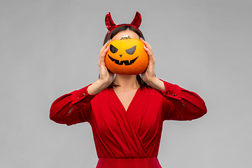 Image showing woman in halloween costume of devil with pumpkin