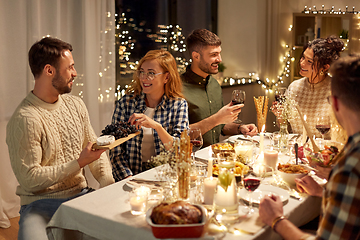 Image showing happy friends having christmas dinner at home