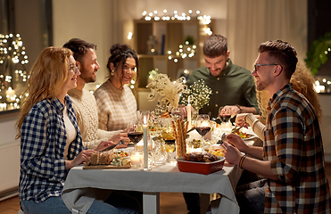 Image showing happy friends having christmas dinner at home