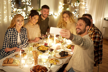Image showing friends taking selfie at christmas dinner party