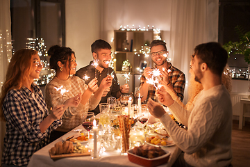 Image showing happy friends having christmas dinner at home