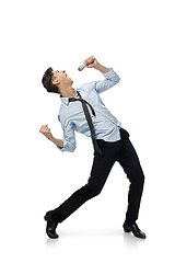 Image showing Happy young man dancing in casual clothes or suit, remaking legendary moves of celebrity from culture history