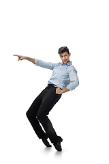 Image showing Happy young man dancing in casual clothes or suit, remaking legendary moves of celebrity from culture history