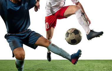 Image showing Close up legs of professional soccer, football players fighting for ball on field isolated on white background