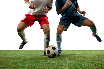 Image showing Close up legs of professional soccer, football players fighting for ball on field isolated on white background