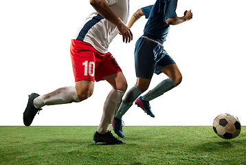 Image showing Close up legs of professional soccer, football players fighting for ball on field isolated on white background