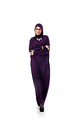 Image showing Beautiful arab woman posing in stylish hijab isolated on studio background. Fashion concept