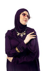 Image showing Beautiful arab woman posing in stylish hijab isolated on studio background. Fashion concept