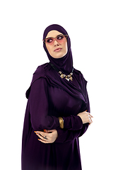 Image showing Beautiful arab woman posing in stylish hijab isolated on studio background. Fashion concept