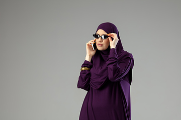 Image showing Beautiful arab woman posing in stylish hijab isolated on studio background. Fashion concept