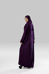 Image showing Beautiful arab woman posing in stylish hijab isolated on studio background. Fashion concept