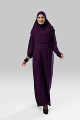 Image showing Beautiful arab woman posing in stylish hijab isolated on studio background. Fashion concept