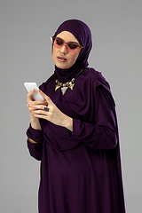 Image showing Beautiful arab woman posing in stylish hijab isolated on studio background. Fashion concept