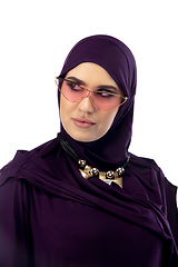 Image showing Beautiful arab woman posing in stylish hijab isolated on studio background. Fashion concept