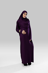 Image showing Beautiful arab woman posing in stylish hijab isolated on studio background. Fashion concept