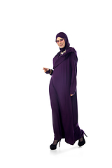 Image showing Beautiful arab woman posing in stylish hijab isolated on studio background. Fashion concept