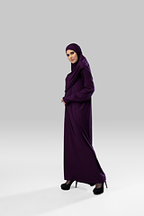 Image showing Beautiful arab woman posing in stylish hijab isolated on studio background. Fashion concept