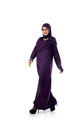 Image showing Beautiful arab woman posing in stylish hijab isolated on studio background. Fashion concept