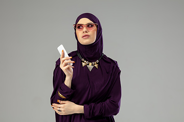 Image showing Beautiful arab woman posing in stylish hijab isolated on studio background. Fashion concept