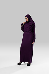 Image showing Beautiful arab woman posing in stylish hijab isolated on studio background. Fashion concept