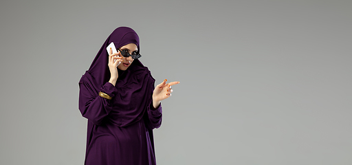 Image showing Beautiful arab woman posing in stylish hijab isolated on studio background. Fashion concept