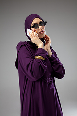 Image showing Beautiful arab woman posing in stylish hijab isolated on studio background. Fashion concept