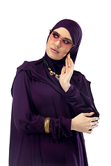 Image showing Beautiful arab woman posing in stylish hijab isolated on studio background. Fashion concept