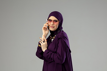 Image showing Beautiful arab woman posing in stylish hijab isolated on studio background. Fashion concept