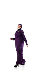 Image showing Beautiful arab woman posing in stylish hijab isolated on studio background. Fashion concept